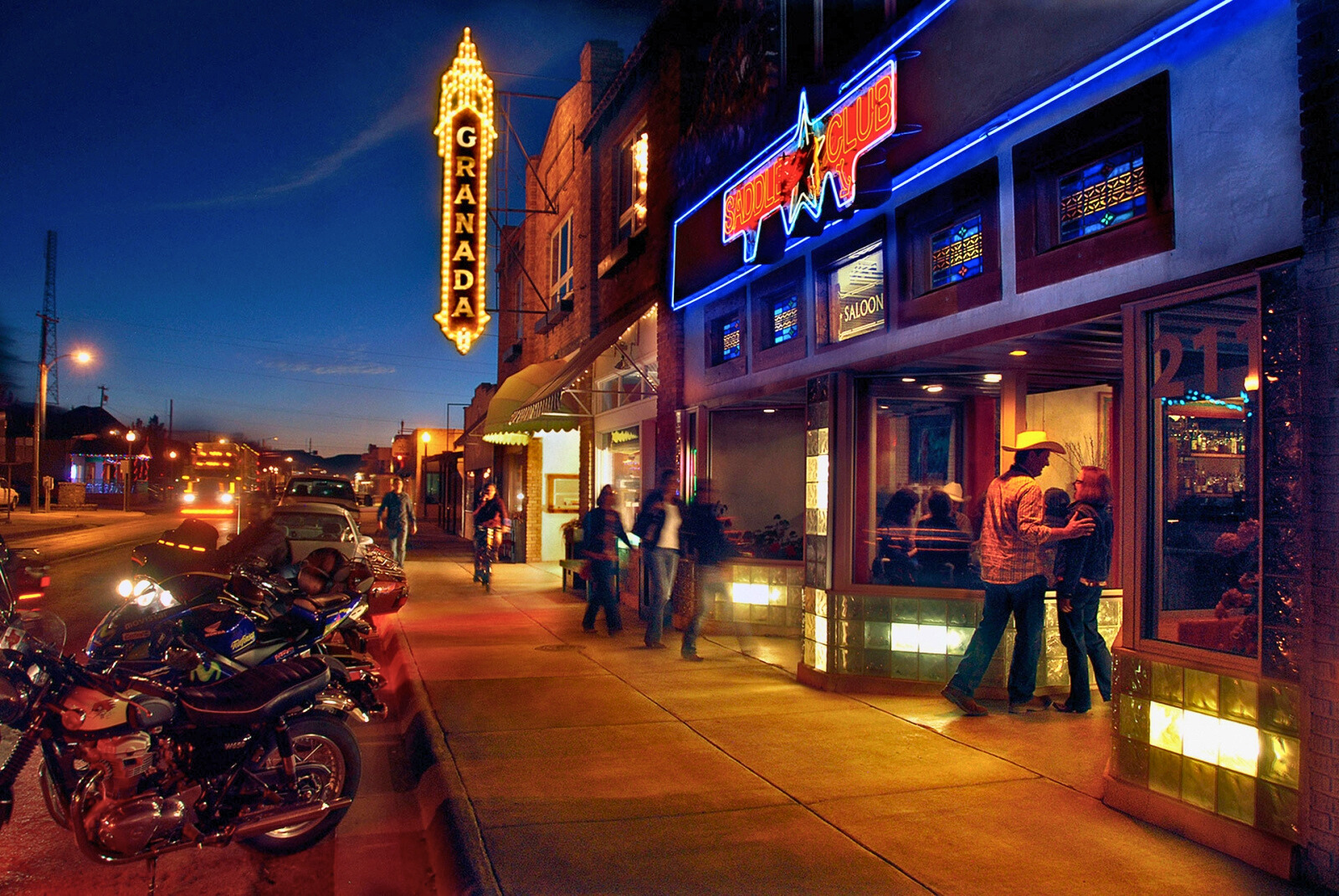 Historic downtown Alpine street view at dusk with Granada Theatre neon sign